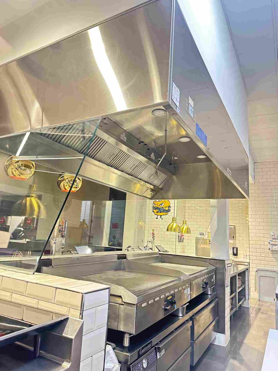 Commercial kitchen exhaust hood installed over flat top griddle & cookline in Atlanta, GA